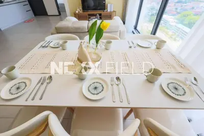 a white table with plates and utensils on it at Urban Suites Penang by Nexx Field in Jelutong