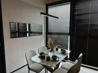 a dining room table with white chairs and a table with cups at High Floor, 3BR 3queen bed, 2 parking, Urban Suites by XWHome in Jelutong
