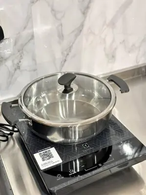 a pan sitting on top of a stove at URBAN Suites Modern Pinky 6pax 3queen 3Bedroom 2Bathroom 2Carpark with Infinity Pool in Jelutong