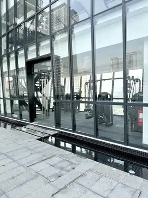 a large glass building with a view of the city at URBAN Suites Modern Pinky 6pax 3queen 3Bedroom 2Bathroom 2Carpark with Infinity Pool in Jelutong