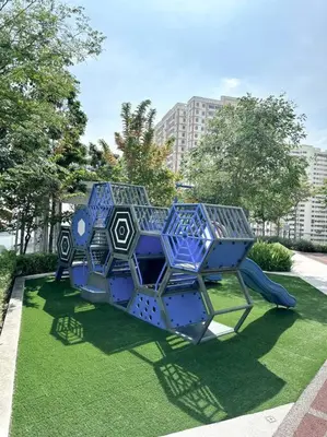 a blue play structure sitting on the grass at URBAN Suites Modern Pinky 6pax 3queen 3Bedroom 2Bathroom 2Carpark with Infinity Pool in Jelutong