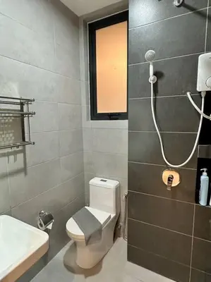 a bathroom with a toilet and a sink and a shower at URBAN Suites Modern Pinky 6pax 3queen 3Bedroom 2Bathroom 2Carpark with Infinity Pool in Jelutong