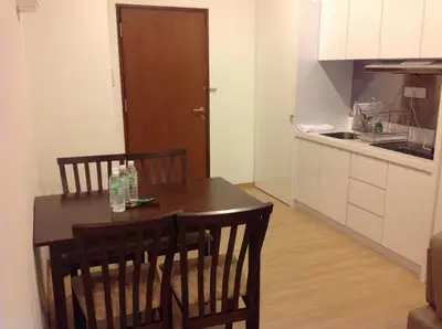 a kitchen with a table and chairs in a room at WenCozy 118 Vacation Home in George Town