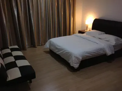 a bedroom with a bed and a table with a lamp at WenCozy 118 Vacation Home in George Town