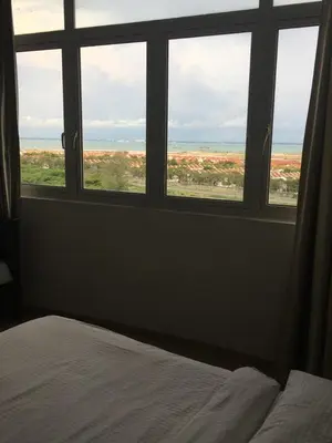 a bedroom with a window looking out at the desert at WenCozy 118 Vacation Home in George Town