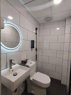 a bathroom with a toilet and a sink and a mirror at The great hotel greenhill in Ipoh