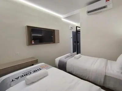 a hotel room with two beds and a tv at The great hotel greenhill in Ipoh