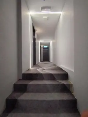 a long hallway with stairs in a building at The great hotel greenhill in Ipoh