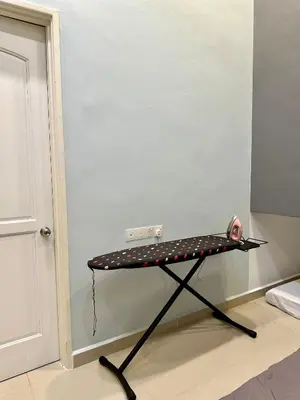 a iron table with polka dots on it next to a door at Stylish Villa Alma 18-23 Guests - Pool, KTV & BBQ in Simpang Ampat