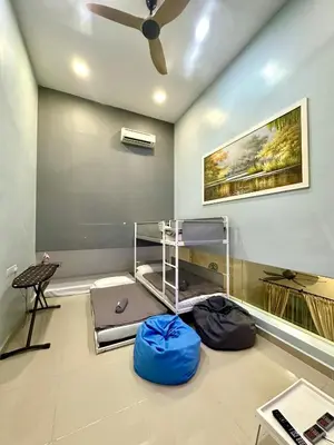 a room with bunk beds and a ceiling fan at Stylish Villa Alma 18-23 Guests - Pool, KTV & BBQ in Simpang Ampat