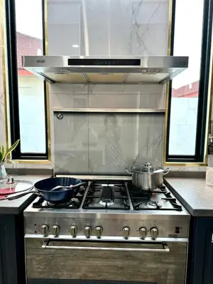 a stove top with two pots and pans on it at Stylish Villa Alma 18-23 Guests - Pool, KTV & BBQ in Simpang Ampat