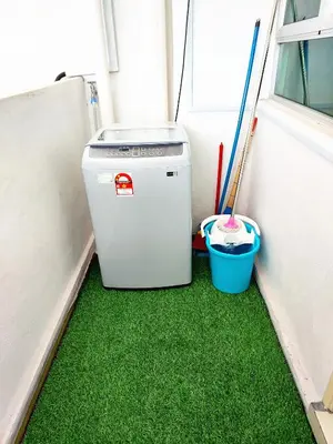 a small refrigerator in a room with green grass at TuR05-Pisa Stadium-3room-Private in Bayan Lepas