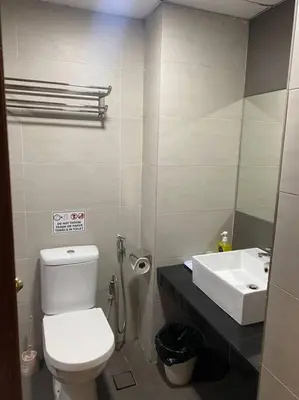 a bathroom with a white toilet and a sink at Brinchang Cameron 2R2B 10 paxs KeaFarm #14402 in Brinchang