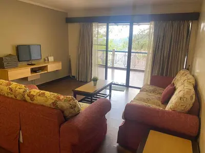 a living room with two couches and a television at Brinchang Cameron 2R2B 10 paxs KeaFarm #14402 in Brinchang