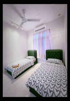 a room with two beds in a room with a ceiling at M & V butterworth in Butterworth
