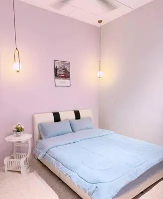 a white bedroom with a blue bed and two lights at M & V butterworth in Butterworth