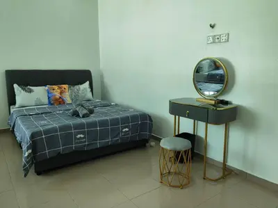 a bedroom with a bed and a mirror and a stool at Cozy Deluxe House Padang Serai 28pax in Padang Serai