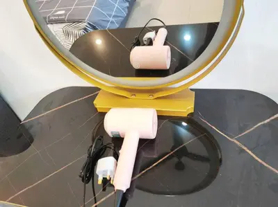 a mirror with two headphones on top of it at Cozy Deluxe House Padang Serai 28pax in Padang Serai