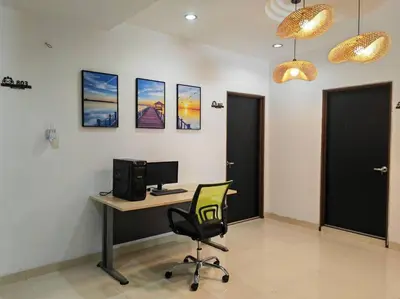 an office with a desk with a computer and a chair at Cozy Deluxe House Padang Serai 28pax in Padang Serai
