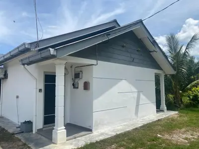 a small white building with a blue roof at Pintu B Damai D'Sawah in Kampong Parit Fourteen