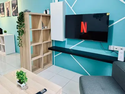 a living room with a tv on a blue wall at Ipoh Midtown Anderson Suite 2R2B in Ipoh