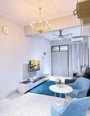 a living room with a blue couch and a tv at Mk&V butterworth in Butterworth