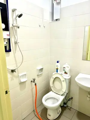 a bathroom with a toilet and a sink at Spc Arena Apartment Service in Bayan Lepas
