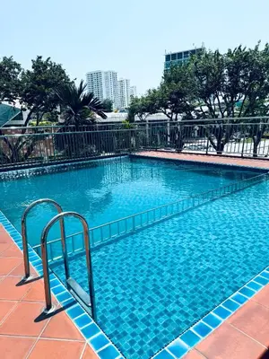 a large swimming pool with blue water at Spc Arena Apartment Service in Bayan Lepas
