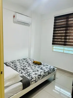 a white room with a bed with a black and white mattress at Spc Arena Apartment Service in Bayan Lepas