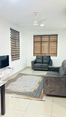 a living room with a couch and a tv at Spc Arena Apartment Service in Bayan Lepas