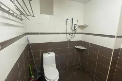 a bathroom with a toilet and a shower at Srinibong hotel apartment in Nibung Tebal