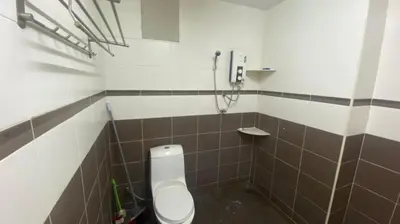 a bathroom with a toilet and a shower at Srinibong hotel apartment in Nibung Tebal