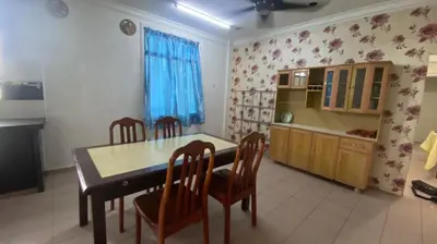 a kitchen with a dining room table and chairs at Srinibong hotel apartment in Nibung Tebal