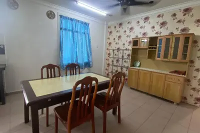 a kitchen with a dining room table and chairs at Srinibong hotel apartment in Nibung Tebal