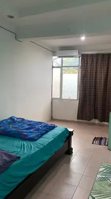 a bedroom with a bed and a window at Srinibong hotel apartment in Nibung Tebal
