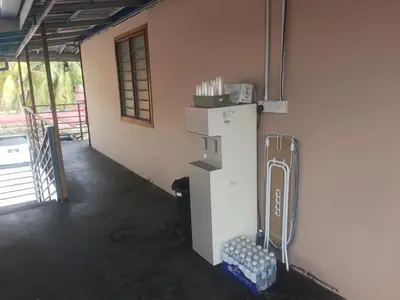 a room with a refrigerator in the corner of a room at Dalya's Roomstay in Tanjung Karang