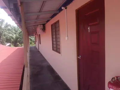 an open door of a house with a porch at Dalya's Roomstay in Tanjung Karang
