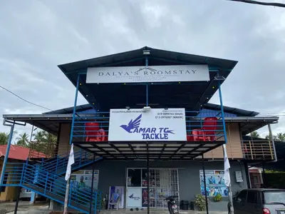 a building with a sign on top of it at Dalya's Roomstay in Tanjung Karang