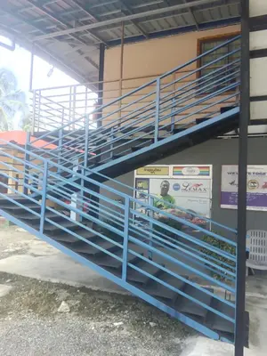 a stack of blue bleachers in a building at Dalya's Roomstay in Tanjung Karang