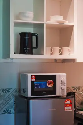a microwave sitting on top of a refrigerator at Anderson Mountain View by Xuites-6 Pax-Free Netflix-6 mins to Concubine Lane in Ipoh