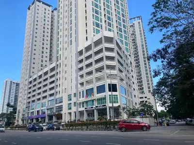 a red car parked in front of a large building at Straits Garden Suites Georgetown Penang 1BRcondo in George Town