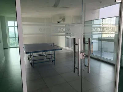 a ping pong table in the middle of a room at Straits Garden Suites Georgetown Penang 1BRcondo in George Town