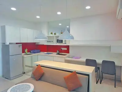 a kitchen with a couch and a table in it at Straits Garden Suites Georgetown Penang 1BRcondo in George Town
