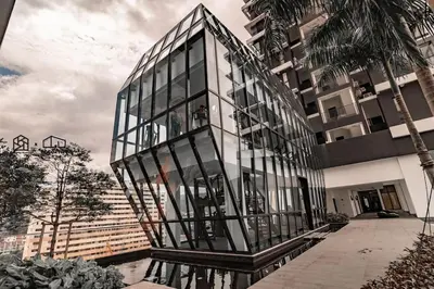 a glass building in front of a building at UA19 #3BR 3 Queen Bed #Family Staycation in Jelutong