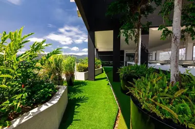 a courtyard of a building with grass and plants at #U27 #3BR Family Staycation in Jelutong