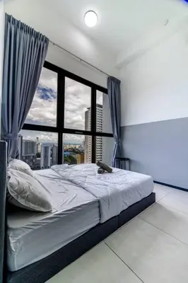 a bed in a room with a large window at #U27 #3BR Family Staycation in Jelutong