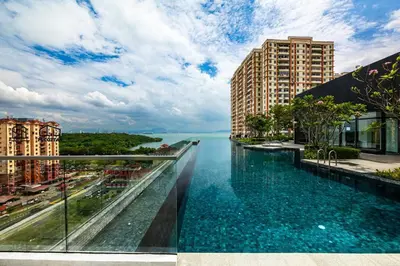 a infinity pool with a view of the water at #U27 #3BR Family Staycation in Jelutong