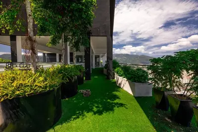 a green yard with plants and trees in a building at #U27 #3BR Family Staycation in Jelutong
