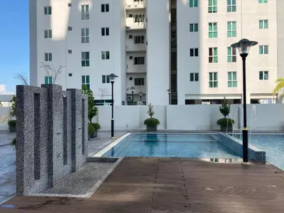 a swimming pool in front of a building at 1BR Condo Straits Garden Suites Georgetown Penang in George Town