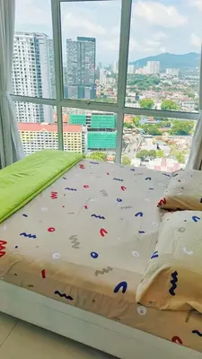 a bed in a room with a large window at 1BR Condo Straits Garden Suites Georgetown Penang in George Town